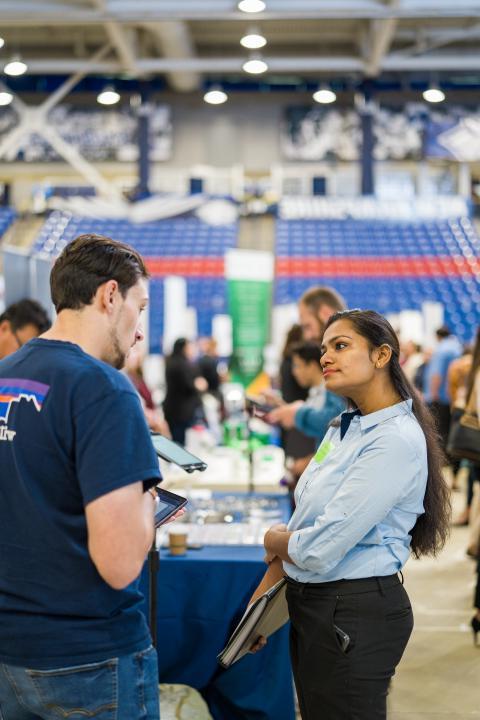 Image of student meeting with a visiting employer at the University of New Hampshire's Career and Internship Fair
