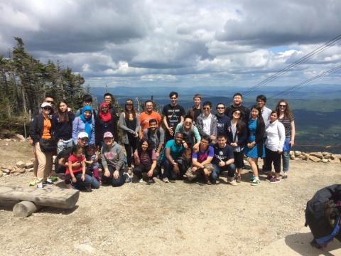 students and scholars on top of a mountain