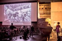 film screening outside in Bologna with large audience watching