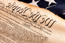 A photo of the U.S. Constitution with a flag