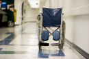 photo of wheelchair in empty hospital hallway